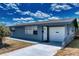 Charming single-story home with a garage, front door, and well-maintained walkway at 30 Azalea Dr, Ormond Beach, FL 32176
