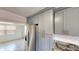 Kitchen area with updated gray cabinetry, stainless steel appliances, and tile backsplash at 30 Azalea Dr, Ormond Beach, FL 32176