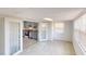 Bright living area with gray tile floors, white walls and a modern, compact kitchen at 30 Azalea Dr, Ormond Beach, FL 32176