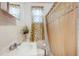 Bathroom with a standard sink, toilet, and shower with decorative curtain at 322 Garden St, Daytona Beach, FL 32114