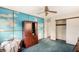 Bedroom with neutral walls, blue carpet, and built in storage at 322 Garden St, Daytona Beach, FL 32114