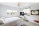 Bedroom featuring neutral carpet, a ceiling fan, and two windows with views of the yard at 322 Garden St, Daytona Beach, FL 32114