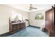 Bedroom with two windows, neutral walls, and blue carpet at 322 Garden St, Daytona Beach, FL 32114