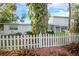 Charming two-story home featuring a picket fence, bromeliads, and lush landscaping at 322 Garden St, Daytona Beach, FL 32114