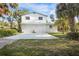 Charming two-story home with two-car garage, surrounded by lush tropical landscaping and sunny skies at 322 Garden St, Daytona Beach, FL 32114