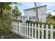 Exterior view of a well-maintained home, showcasing its classic design, a white picket fence, and landscaped surroundings at 322 Garden St, Daytona Beach, FL 32114