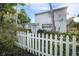 Exterior view of a well-maintained home, showcasing its classic design, a white picket fence, and landscaped surroundings at 322 Garden St, Daytona Beach, FL 32114
