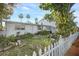 Exterior view of a home, landscaped surroundings and a white picket fence enhance the curb appeal at 322 Garden St, Daytona Beach, FL 32114