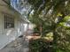 Side exterior of white building with tropical landscaping and secure windows in a sunny environment at 322 Garden St, Daytona Beach, FL 32114