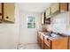 Kitchen with wooden cabinets, stainless steel sink, and view to the exterior at 322 Garden St, Daytona Beach, FL 32114