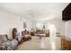 Living room featuring wood-look floors, a ceiling fan, and a large window at 322 Garden St, Daytona Beach, FL 32114