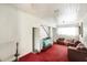 Living room with red carpet, multiple couches, and white wood paneled walls and ceilings at 322 Garden St, Daytona Beach, FL 32114