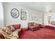 Cozy living room with red carpet, comfortable seating, and unique wall decor at 322 Garden St, Daytona Beach, FL 32114