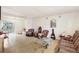 Bright living room featuring wood flooring, a ceiling fan, and access to the enclosed porch at 322 Garden St, Daytona Beach, FL 32114