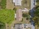 Aerial view of a home showcasing its roof, driveway, and surrounding greenery at 3385 Ne 44Th Pl, Ocala, FL 34479