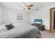 Bright bedroom featuring neutral walls, a ceiling fan, and a large window at 3385 Ne 44Th Pl, Ocala, FL 34479