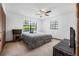 Bedroom with neutral carpet, a ceiling fan, and large windows at 3385 Ne 44Th Pl, Ocala, FL 34479