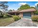 Traditional brick home with an attached garage and neatly trimmed landscaping at 3385 Ne 44Th Pl, Ocala, FL 34479