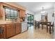 Kitchen and dining area featuring wood cabinets and a sliding glass door to the patio at 3385 Ne 44Th Pl, Ocala, FL 34479