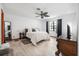 Spacious main bedroom with a ceiling fan, large window, and light wood flooring at 3385 Ne 44Th Pl, Ocala, FL 34479