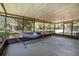 Relaxing screened porch featuring a comfortable hammock and views of the backyard at 3385 Ne 44Th Pl, Ocala, FL 34479