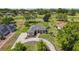 Aerial view of a house with a curved driveway, lush landscaping, and a well-manicured lawn at 39601 Harbor Hills Blvd, Lady Lake, FL 32159