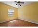 Sunny bedroom with hardwood floors, a ceiling fan, and natural light from the window at 39601 Harbor Hills Blvd, Lady Lake, FL 32159