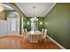 Formal dining area with stylish chandelier, complemented by green walls and bright lighting at 39601 Harbor Hills Blvd, Lady Lake, FL 32159