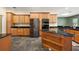 Well-equipped kitchen with wood cabinets, stainless steel appliances, and dark granite countertops at 39601 Harbor Hills Blvd, Lady Lake, FL 32159
