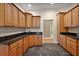 Functional kitchen boasts granite counters, dark floors, ample cabinetry, and stainless sink at 39601 Harbor Hills Blvd, Lady Lake, FL 32159