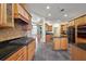 Gourmet kitchen featuring an island cooktop, granite counters, and seamless access to the living spaces at 39601 Harbor Hills Blvd, Lady Lake, FL 32159