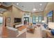 Bright living room features neutral walls and flooring, furniture, and a view into the kitchen at 39601 Harbor Hills Blvd, Lady Lake, FL 32159