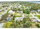 Aerial view of property in a neighborhood setting with lush landscaping, mature trees, well-maintained lawn and community access at 59 Amsden Rd, Ormond Beach, FL 32176