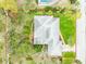 Aerial view highlighting the property lines, lush landscaping, mature trees, and the overall layout of the home and yard at 59 Amsden Rd, Ormond Beach, FL 32176