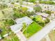 The property features a lush, landscaped yard, mature trees, and an extended driveway leading to the front of the house at 59 Amsden Rd, Ormond Beach, FL 32176
