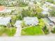 Aerial view of the house showcasing its well-maintained yard, driveway, and mature trees offering shade and privacy at 59 Amsden Rd, Ormond Beach, FL 32176
