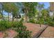 Brick patio with mature trees and greenery in a peaceful backyard setting at 59 Amsden Rd, Ormond Beach, FL 32176