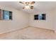 Bedroom with two windows, ceiling fan and wall to wall carpet at 59 Amsden Rd, Ormond Beach, FL 32176
