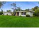 Charming single-story home featuring a well-maintained lawn and bright yellow shutters at 59 Amsden Rd, Ormond Beach, FL 32176