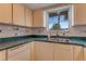 Charming kitchen with white cabinets, a green countertop, and a stainless steel double sink at 59 Amsden Rd, Ormond Beach, FL 32176