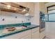 Bright kitchen featuring stainless steel appliances, white cabinets and backsplash with green countertops at 59 Amsden Rd, Ormond Beach, FL 32176