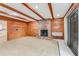Comfortable living room with wood paneled walls, brick fireplace, and plenty of space at 59 Amsden Rd, Ormond Beach, FL 32176