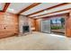 Gathering room with wood paneled walls, brick fireplace, and sliding doors to the outside at 59 Amsden Rd, Ormond Beach, FL 32176