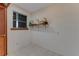 Small office space with tile floors, window, and mounted shelving at 59 Amsden Rd, Ormond Beach, FL 32176
