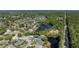 Expansive aerial view of a residential community with lush green landscaping and a tranquil lake at 6172 Knotty Pine Ct, Port Orange, FL 32127