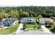 Aerial view showcases a house with a spacious yard and views of a waterway and green landscape at 6172 Knotty Pine Ct, Port Orange, FL 32127