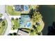 Aerial of a beautiful home, pool and covered patio overlooking a tranquil pond at 6172 Knotty Pine Ct, Port Orange, FL 32127