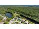 An aerial view of the property backing onto a lush green conservation area and waterway at 6172 Knotty Pine Ct, Port Orange, FL 32127