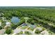 Stunning aerial view of home with lush green surroundings, lake and waterfront access at 6172 Knotty Pine Ct, Port Orange, FL 32127