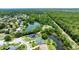 An attractive aerial view of a home with lush green surroundings and waterfront at 6172 Knotty Pine Ct, Port Orange, FL 32127